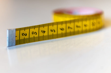 yellow tape measure on a white background