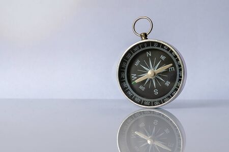 Compass on light background with copy space using as directionの写真素材