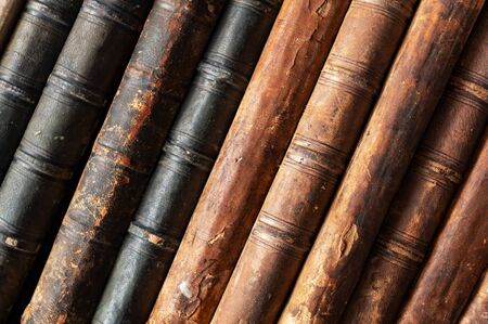stack of old books on a library shelfの写真素材