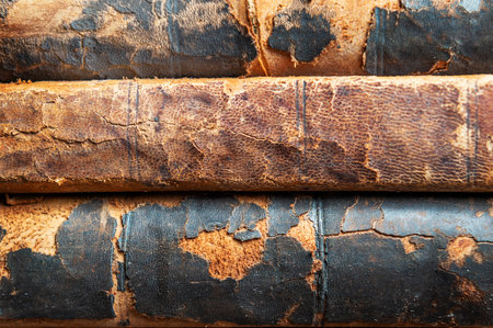 stack of old books on a library shelfの写真素材