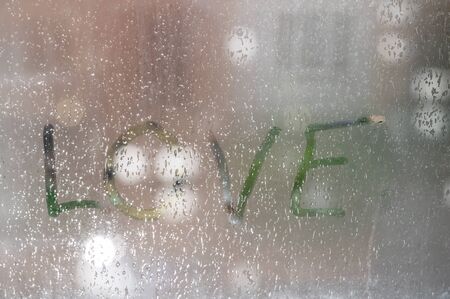 inscription on sweaty glass with drops - loveの写真素材