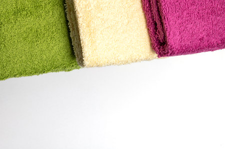 Set of three towels. Three towels of different colors are on a white background.の写真素材