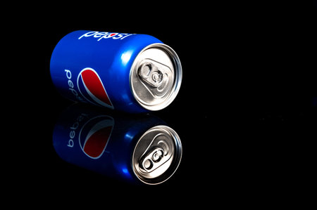 RIVNE, UKRAINE - FEBRUARY 1, 2021: Pepsi can close up. A can of chilled pepsi-cola on a black...