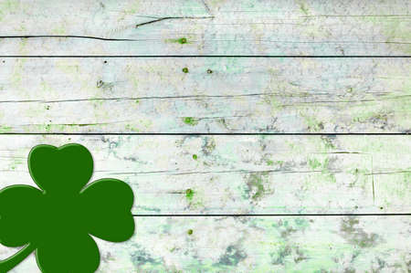 St Patricks day background. Shamrocks over a light green wood background.の写真素材