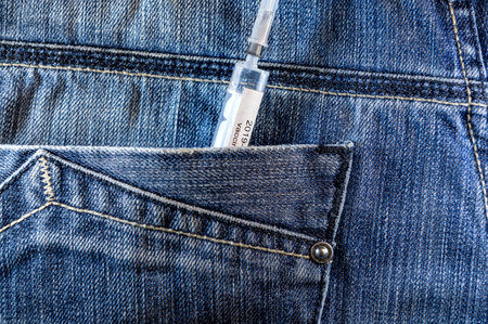 Injection syringe in jeans pocket. Vaccination. Coronavirus vaccineの写真素材