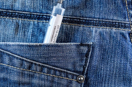 Injection syringe in jeans pocket. Vaccination. Coronavirus vaccineの写真素材