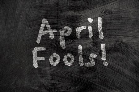 April fools day reminder on blackboard. Be aware. Directly above shotの写真素材