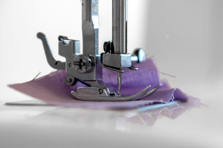 Sewing hobby background. Close up process of sewing on a sewing machine with copy space.