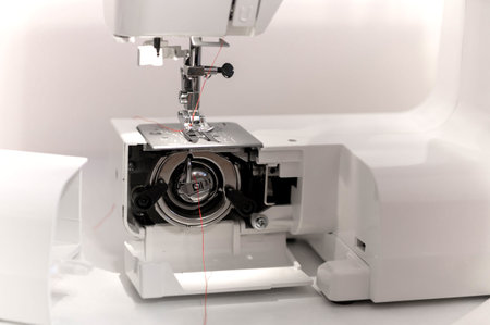 Sewing hobby background. Close up process of sewing on a sewing machine with copy space.