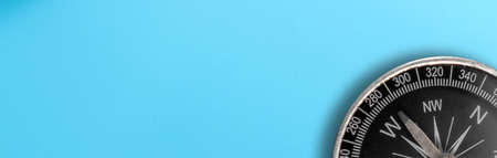 Compass isolated on a blue background. Direction concept. Banner.の写真素材