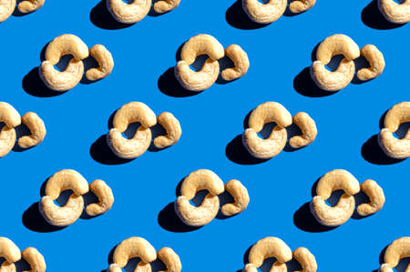 Pattern of cashew. Fashionable sunny porridge pattern on a bright blue background. Colorful pattern. View from aboveの写真素材