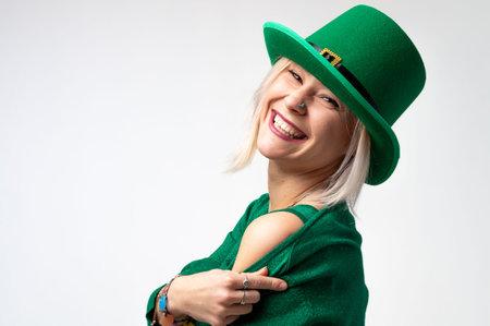 St. Patrick's Day. Beautiful smiling woman wearing green hat. white background