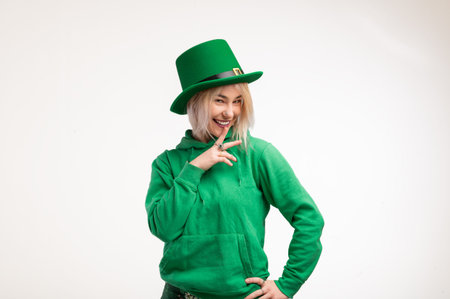 St. Patrick's Day. Beautiful smiling woman wearing green hat. white background