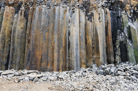 Basalt pillars in a quarry. Natural basalt rock columns texture. Abstract natural background or...