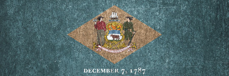 Banner of the Delaware state grunge flag. Dirty Delaware state flag on a metal surface.の写真素材