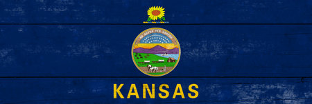 Kansas State flag on a wooden surface. Banner of the grunge Kansas State flag.の写真素材