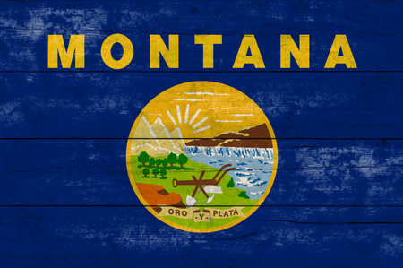 Montana State flag on a wooden surface. Banner of the grunge Montana State flag.の写真素材