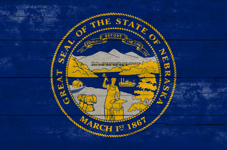Nebraska State flag on a wooden surface. Banner of the grunge Nebraska State flag.の写真素材