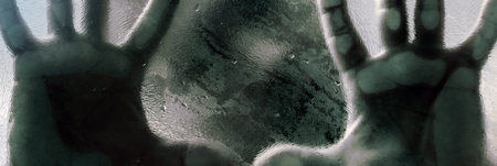 Mans figure with hands pressed against frosted glass. Shadow of a man behind the matte glass blurry...