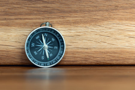 Compass on wooden background with copy space using as directionの写真素材