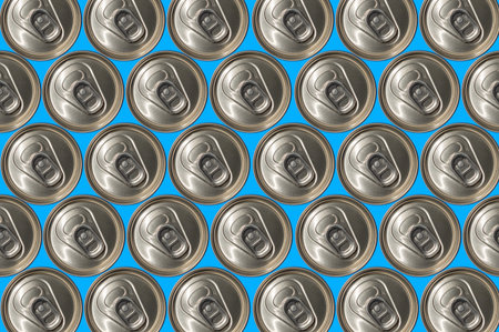 Tops of soda cans. Aluminum cans of soda background. View from the top