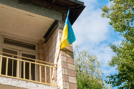Ukrainian flag hangs on the facade of an old building. Blue yellow Ukrainian flag.の写真素材