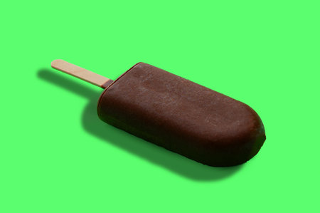 Ice cream in chocolate glaze on a bright green background.の写真素材