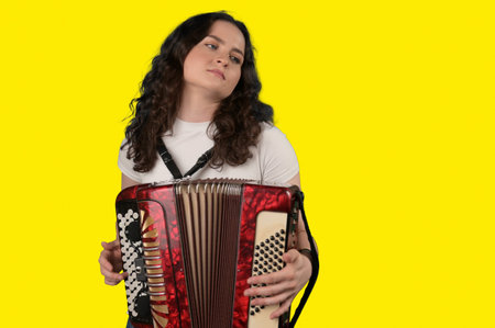 Young woman with a button accordion. Adult woman plays the button accordion
