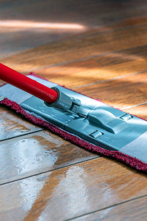 Mop washing a wooden floor in an apartment. Concept of care for the cleanliness of the apartment....