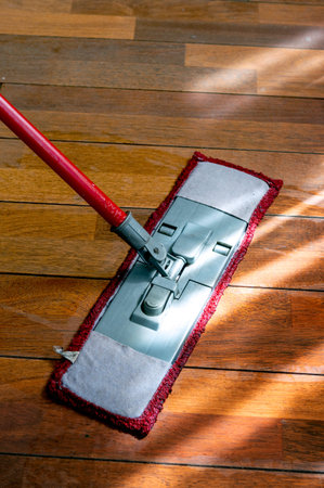 Mop washing a wooden floor in an apartment. Concept of care for the cleanliness of the apartment....
