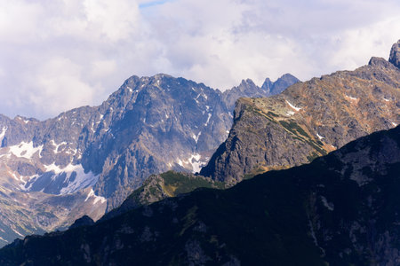 The peaks of the Tatra National Park. View from the blue tourist trail leading from Morskie Oko to the valley of Five Ponds. Picturesque clouds over the peaks.の写真素材