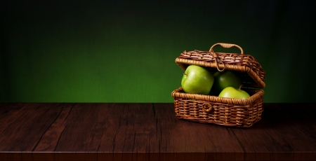 basket of apples on a wooden tableの写真素材