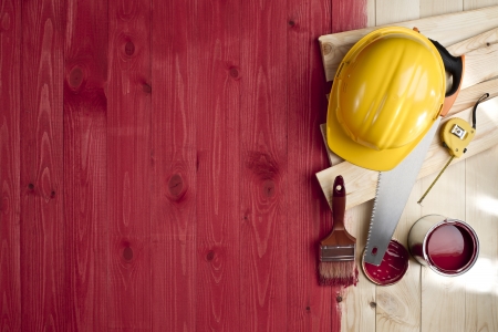 red wood floor with a brush, paint, tools and helmetの写真素材