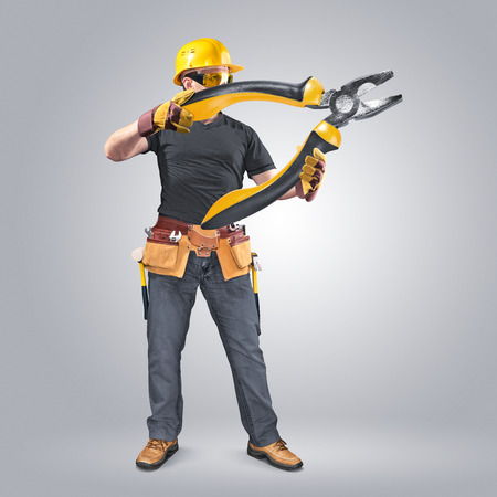 construction worker with tool belt and pliersの写真素材