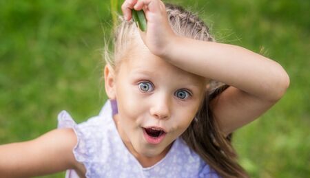 Little girl surprised and delightedの写真素材