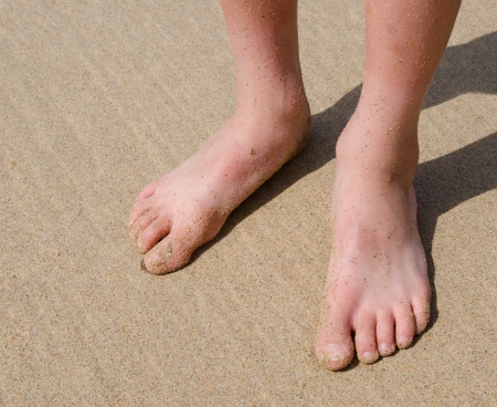 Child s feet on sandの写真素材