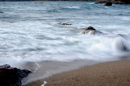 Waves crashing on beach, Cornwall, Englandの写真素材
