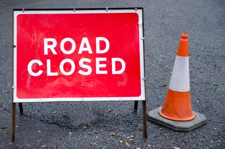 Road closed sign with traffic coneの写真素材