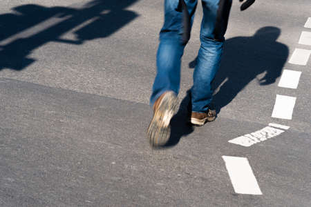 Steps of a man into the shadowの写真素材