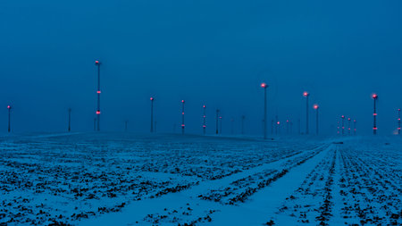 wind farm in the night with a blue sky