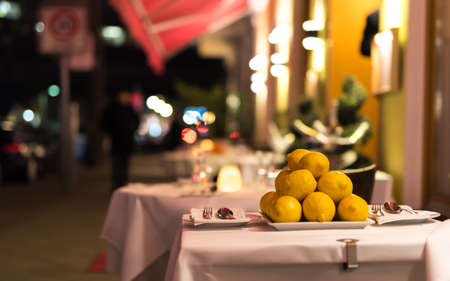 a table outside in the restaurant in the eveningの写真素材