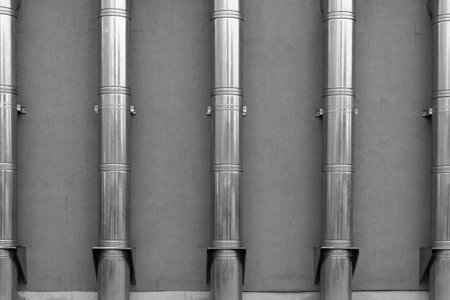 The five exhaust pipes climb up the facadeの写真素材