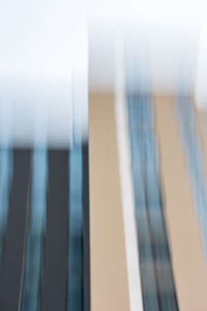 Two closely spaced new homes with long glass facades with blur effectの写真素材