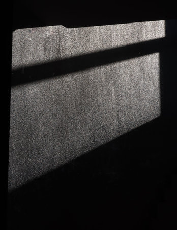 A black window shadow on the gray concrete wall