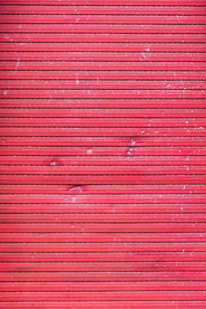A old closed broken red roller shutterの写真素材
