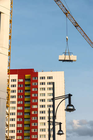 A new building and a skyscraper with a crane with building material. Berlin, Germanyの写真素材