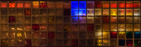 Colorful glass blocks glow in all colors at nightの写真素材