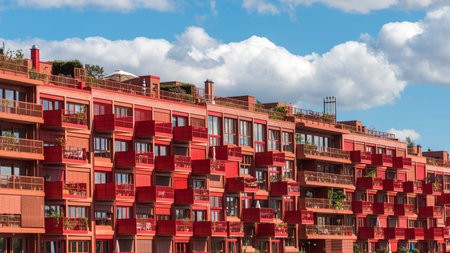 The red house with green plants on the balconies