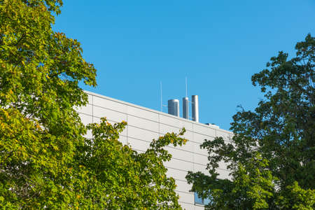 Three steel chimneys on a modern buildingの写真素材