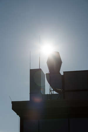Chimneys without smoke and the sun in the backgroundの写真素材